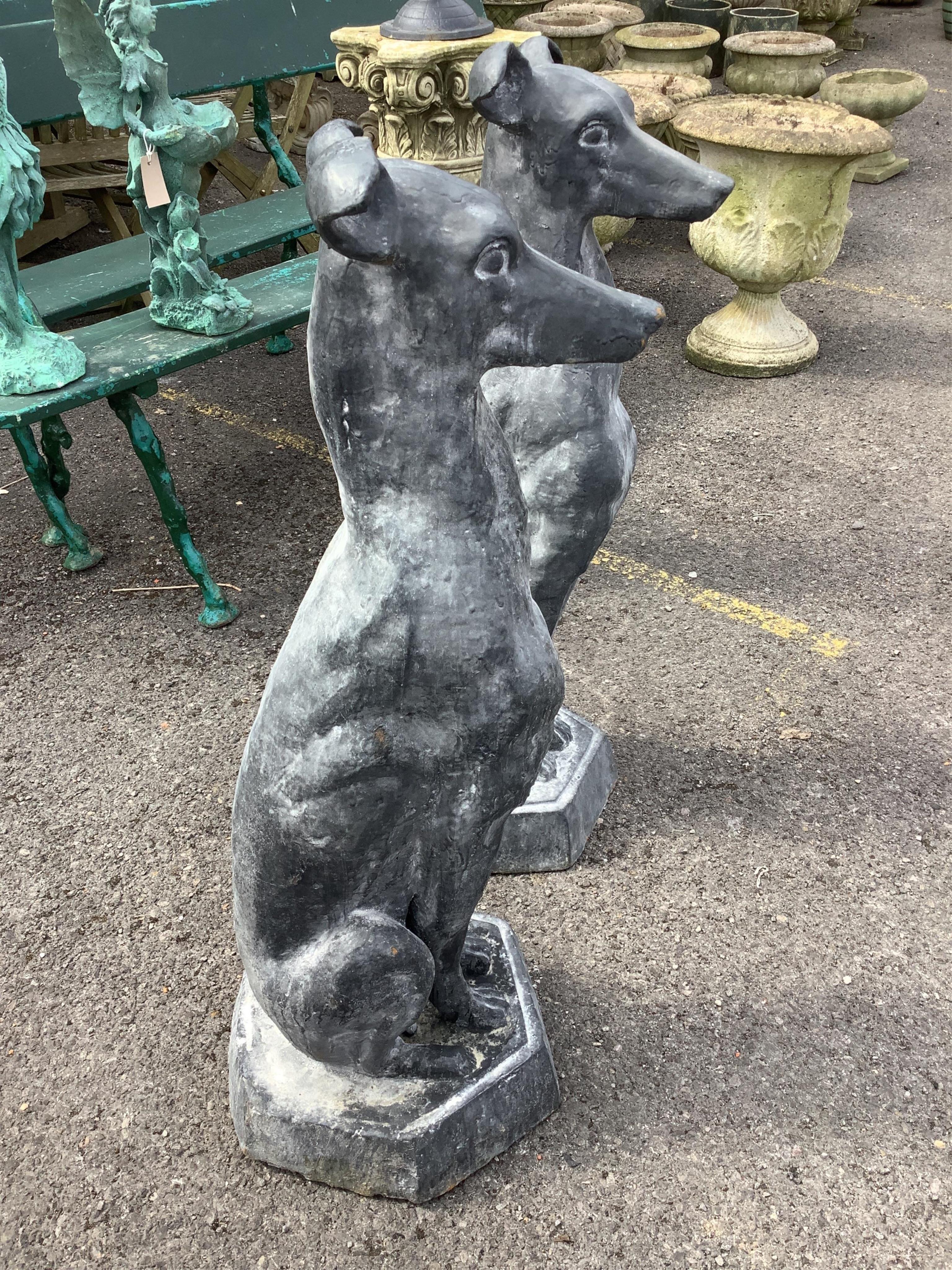 A pair of cast iron faux lead sitting hound garden ornaments, height 92cm. Condition - good